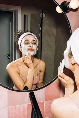 A girl doing her facial skincare